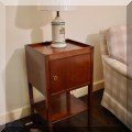 F28. Side table with cabinet door. 